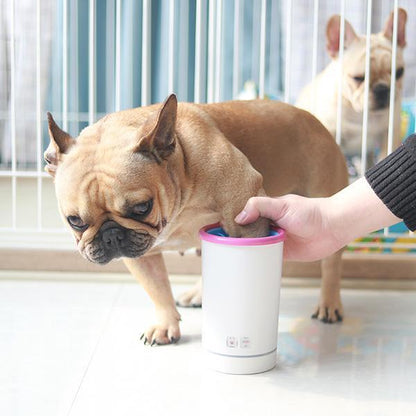 USB paw washing cup in use with a dog getting its paws cleaned.